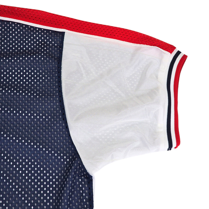 Close-up of a nike team sports team usa jersey with red and blue mesh, white satin, and a tricolore elasticated trim on a white background