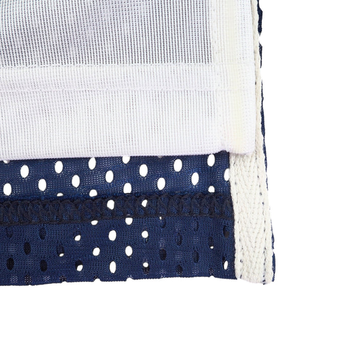 Close-up of woven white and navy blue mesh fabric on a white background