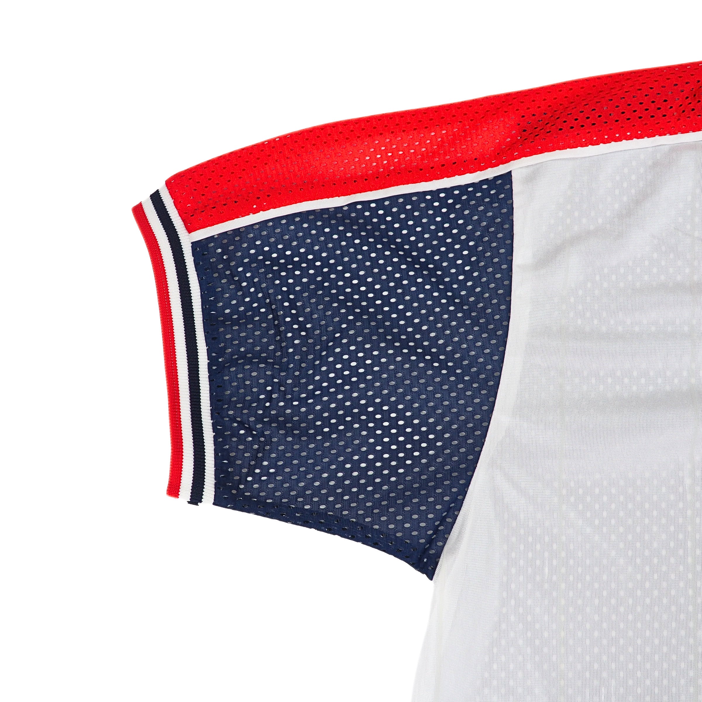 Close-up of a vintage Nike mesh sports jersey with red, white, and blue accents on a white background