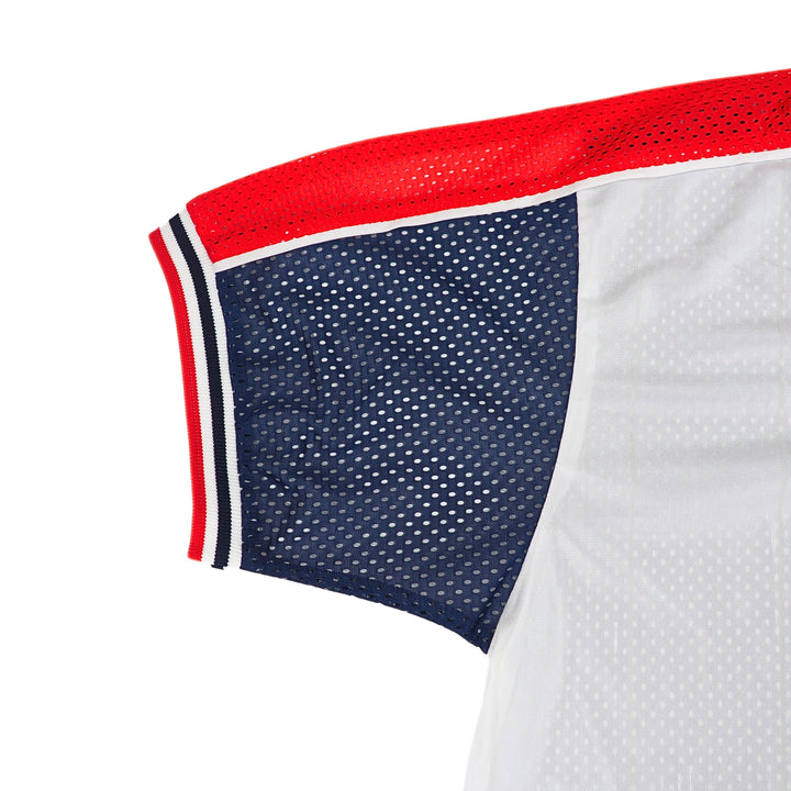 Close-up of a vintage Nike mesh sports jersey with red, white, and blue accents on a white background