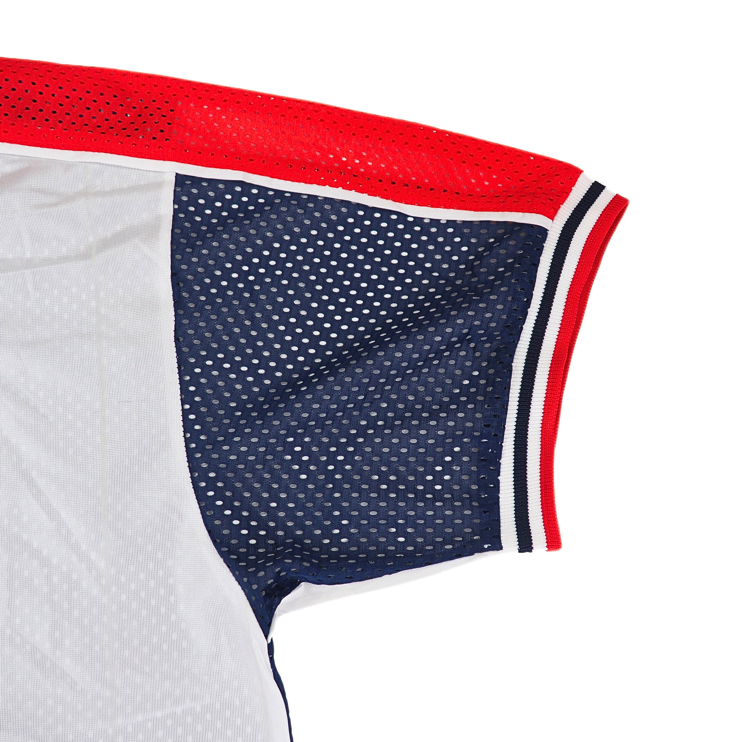 Close-up of a Nike mesh sports jersey with red, white, and blue accents on a white background