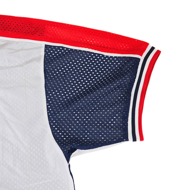 Close-up of a Nike mesh sports jersey with red, white, and blue accents on a white background