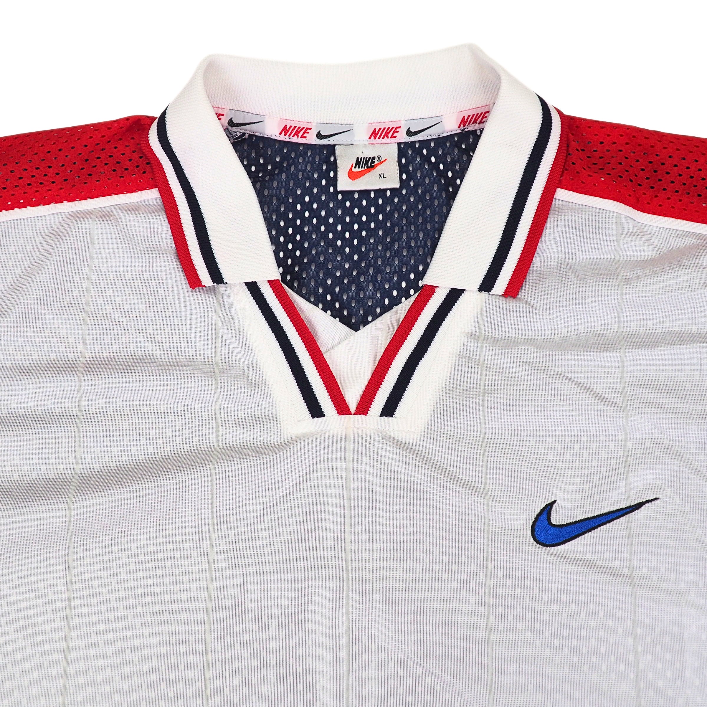 Vintage 90s Team USA white soccer jersey with red and blue accents, featuring Nike logo and swoosh branding.