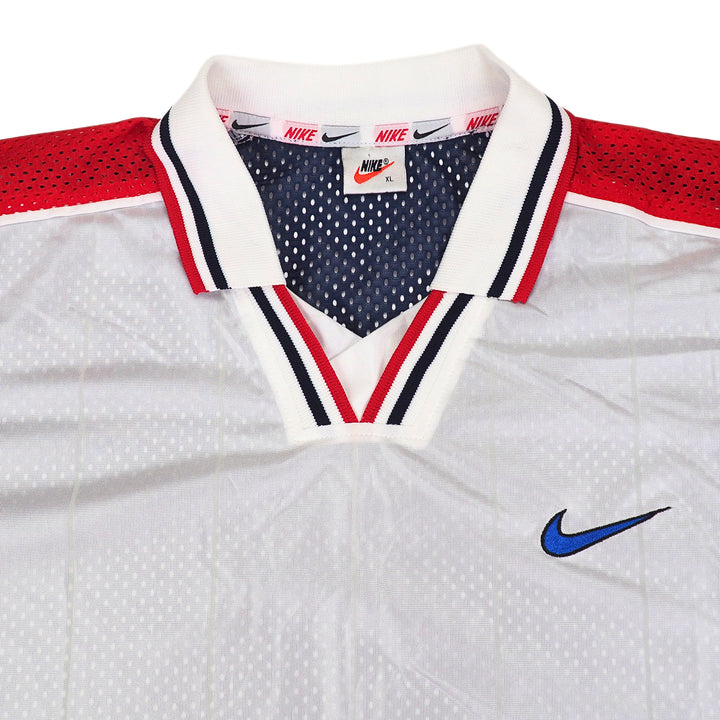 Vintage 90s Team USA white soccer jersey with red and blue accents, featuring Nike logo and swoosh branding.