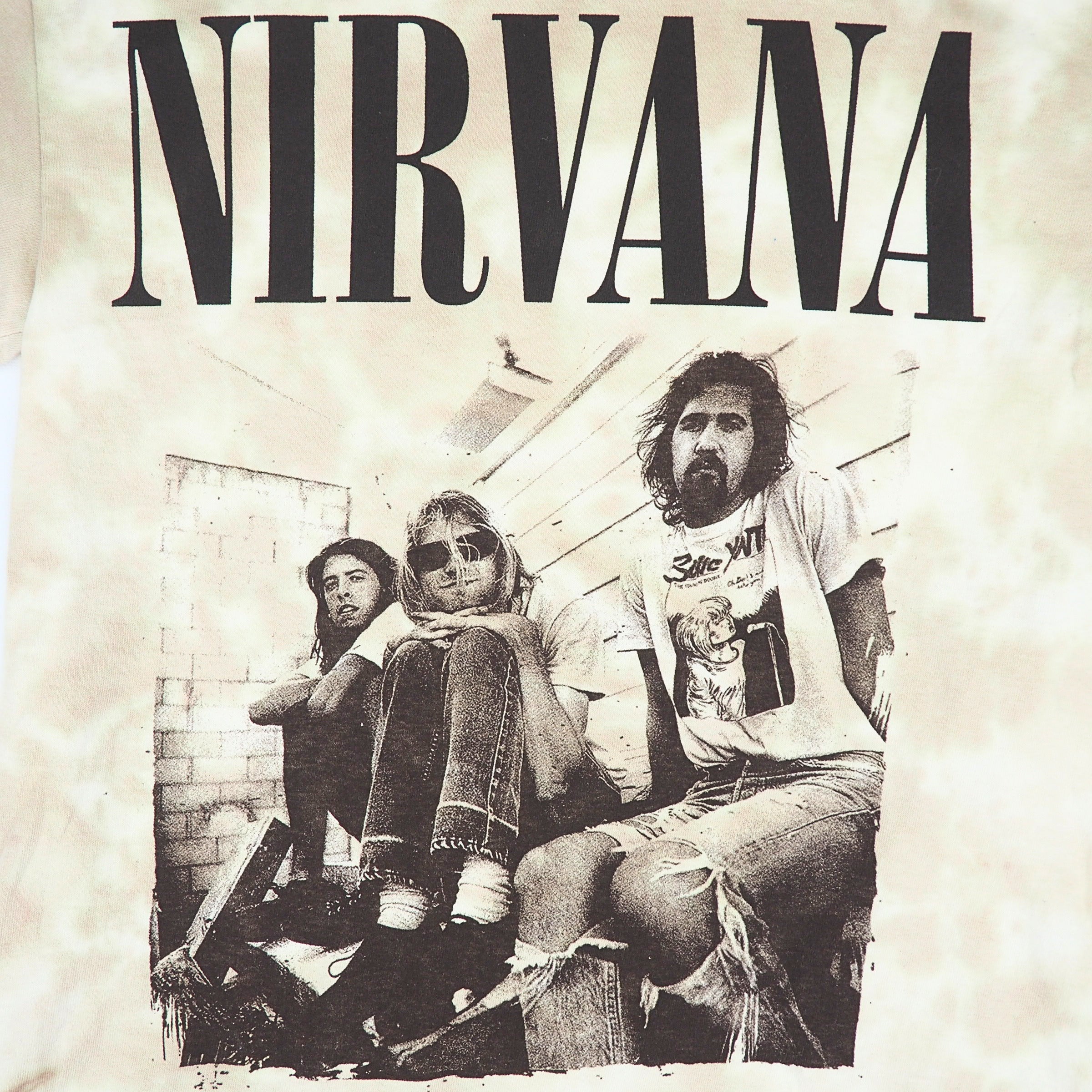 Detail of the graphic on a tie dye Nirvana t-shirt featuring a photo of the band members