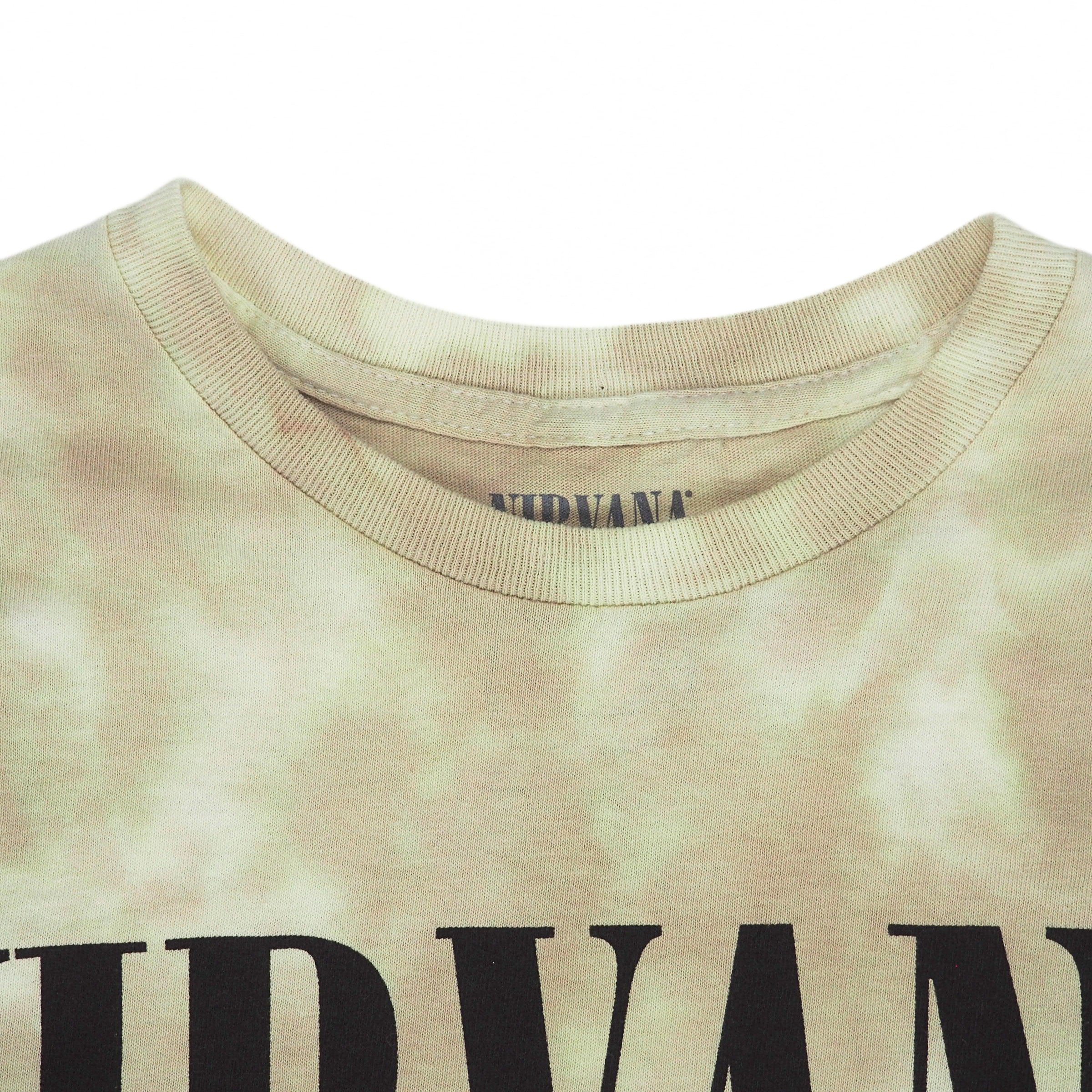 Close up of the collar of a tie dye Nirvana t-shirt on a white background
