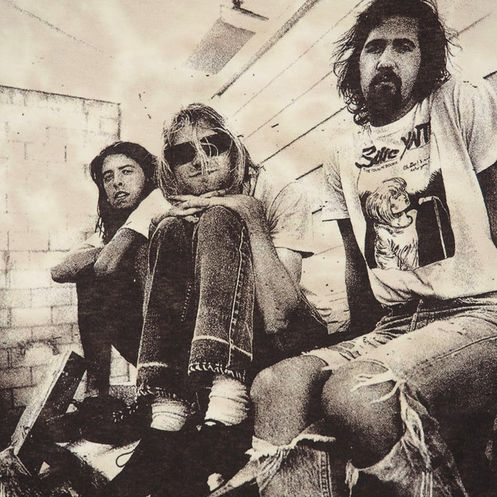 Detail of the graphic on a tie dye Nirvana t-shirt featuring a photo of the band members