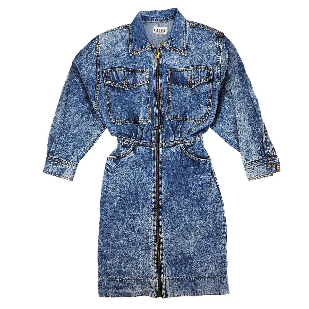 A blue acid-wash denim utility shirt dress with a front zipper, chest flap pockets, and a tie waist, shown flat on a white background.