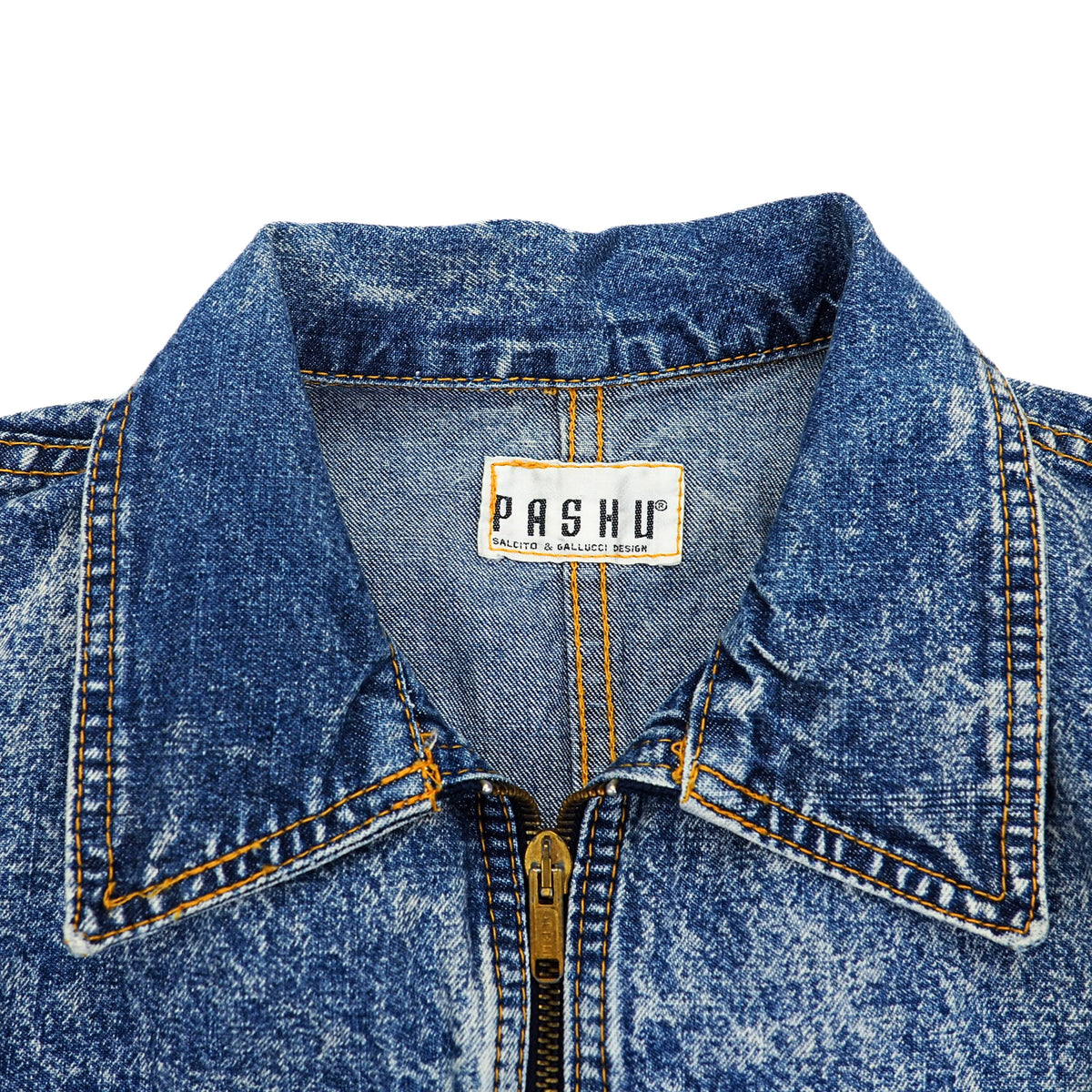Close-up of a blue acid-wash denim jacket collar with a gold-tone zipper and a visible PASHU brand label.