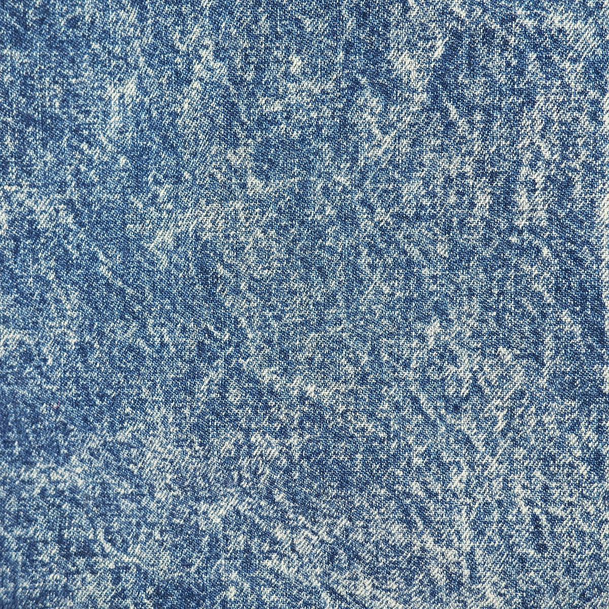 A close-up of textured blue denim fabric with a faded, distressed finish showing the weave pattern.