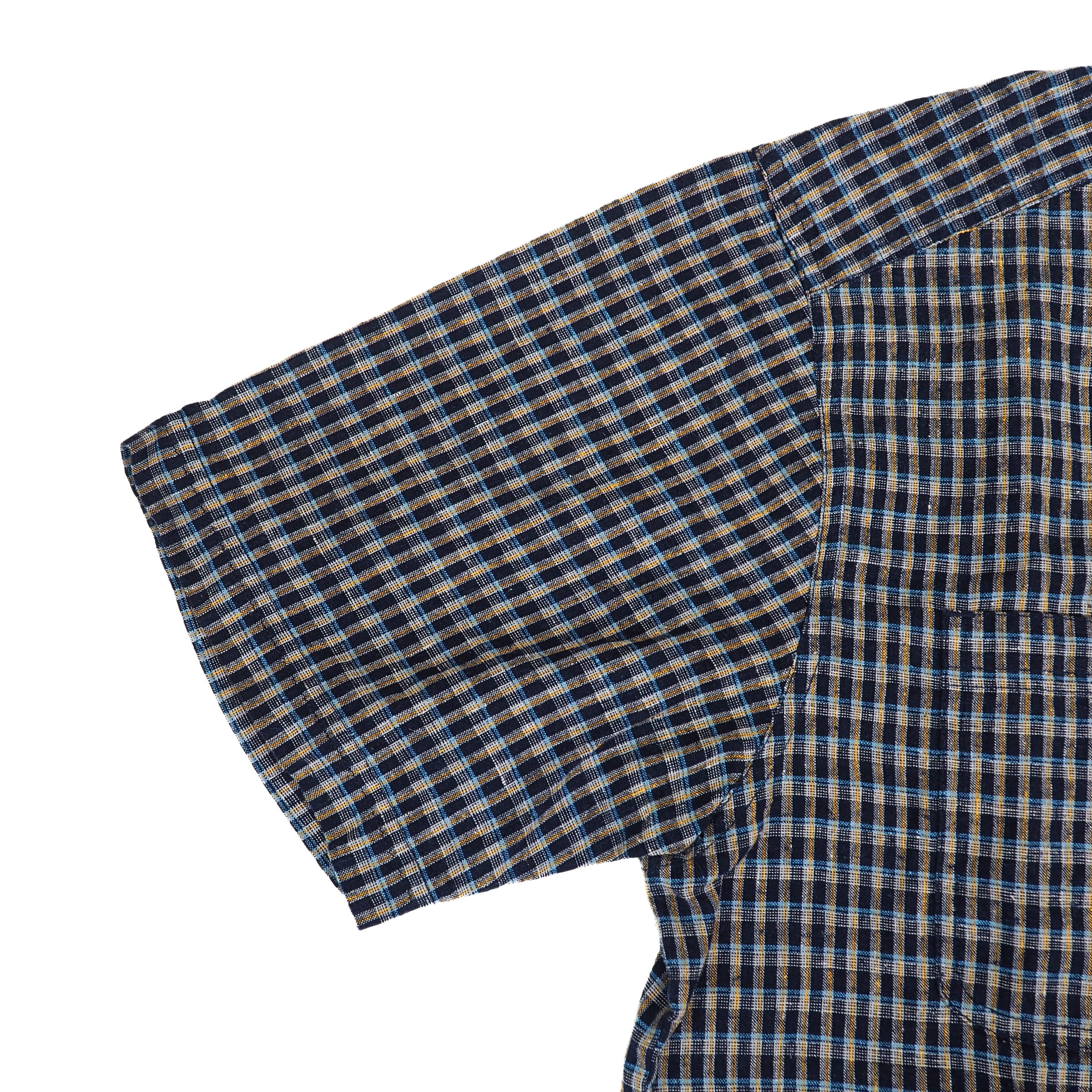 Close-up of a plaid fabric shirt sleeve with blue and brown pattern on a white background