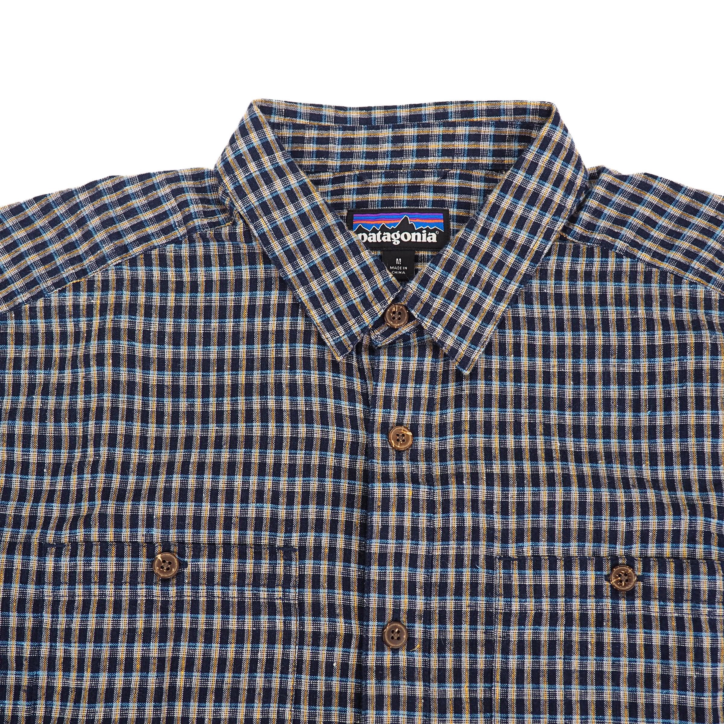 Plaid shirt with Patagonia label on a white background