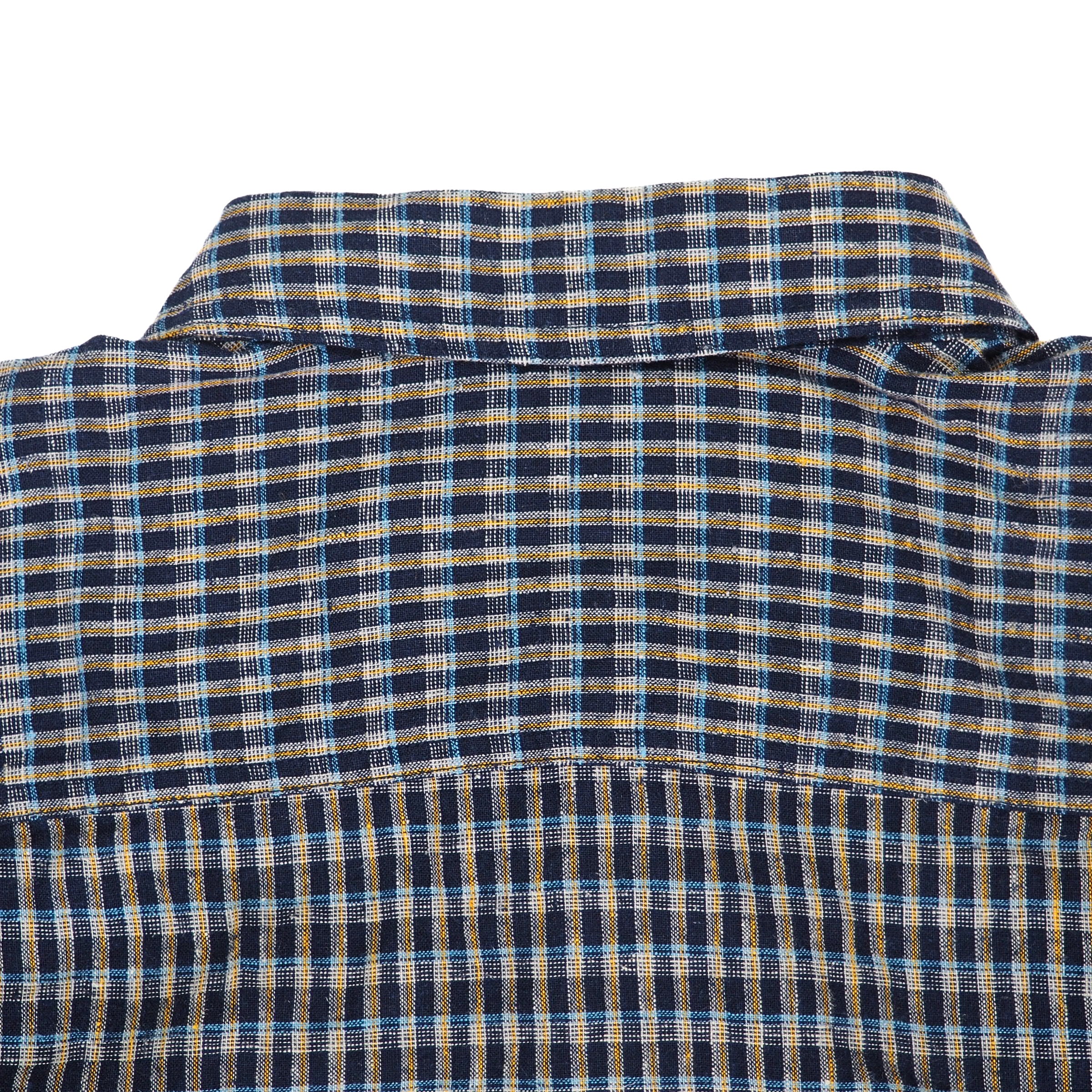 Close-up of a blue and yellow checkered shirt collar on a white background