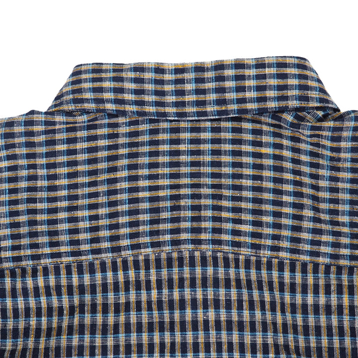 Close-up of a blue and yellow checkered shirt collar on a white background
