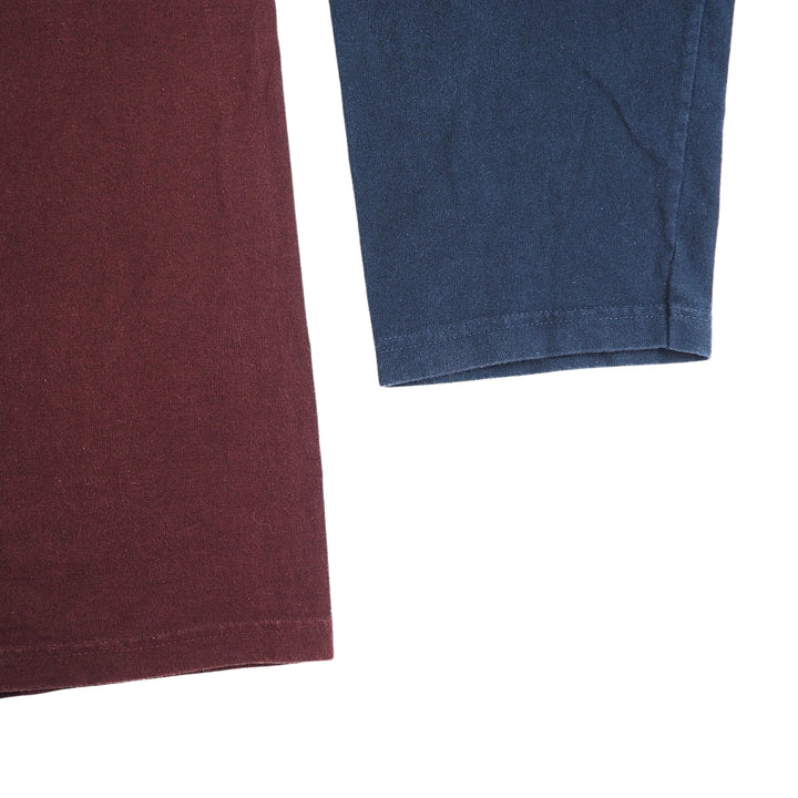 Close-up of two fabric color options, showing a dark burgundy red sleeve and a slate blue sleeve, both laid flat on a white background.