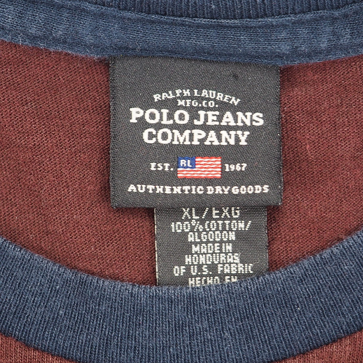 Close-up of a Ralph Lauren Polo Jeans Company neck label on a blue and burgundy colored shirt.