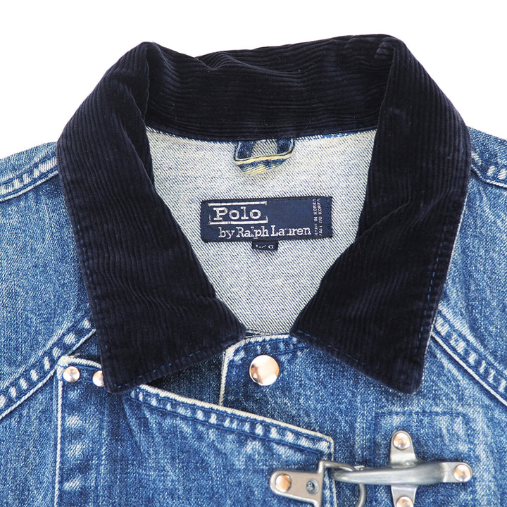 Close-up of a blue denim jacket with a dark navy corduroy collar and silver metal toggle closure, showing the Polo by Ralph Lauren neck label.