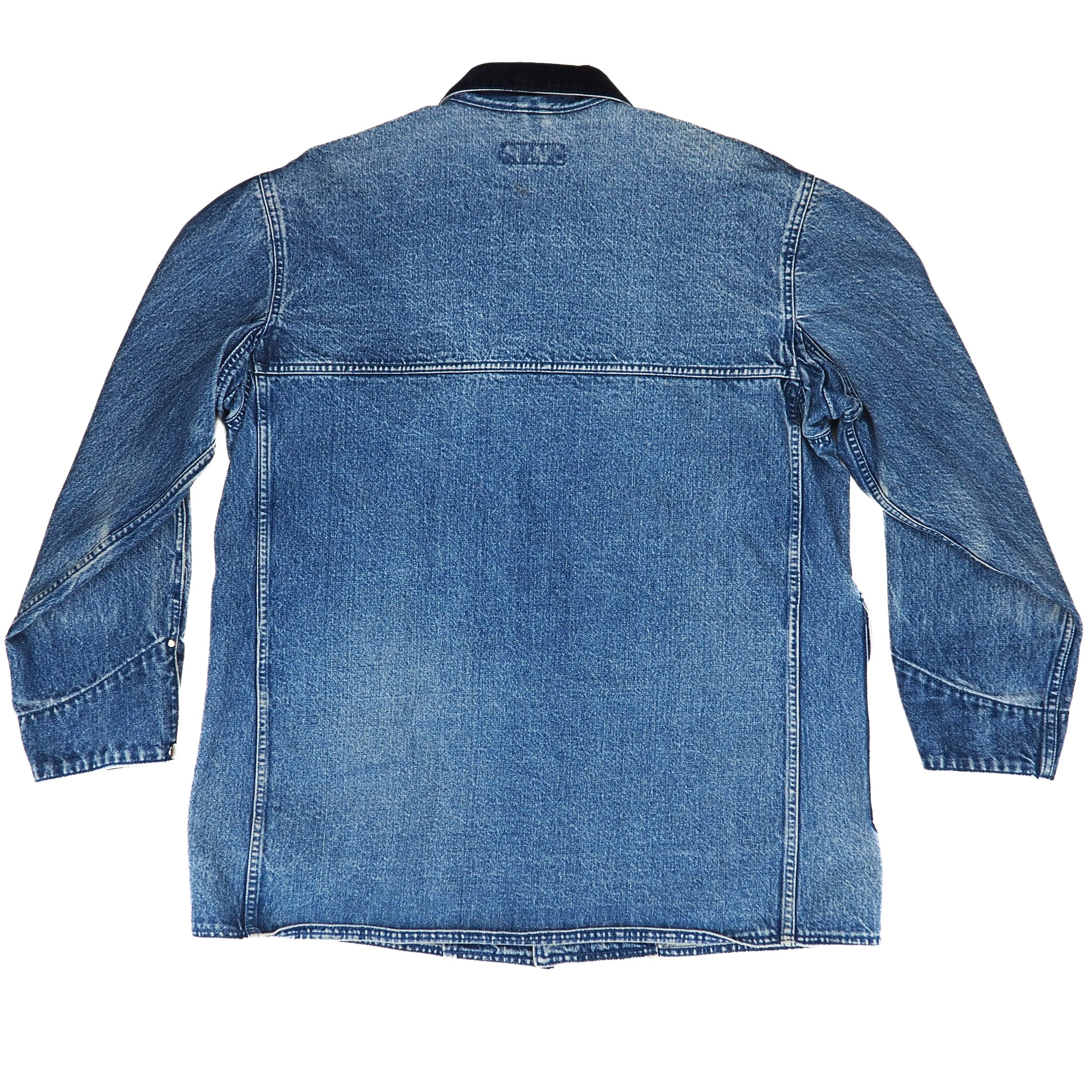 The back view of a blue denim jacket with long sleeves, a pointed collar, and a straight hem, shown on a plain white background.