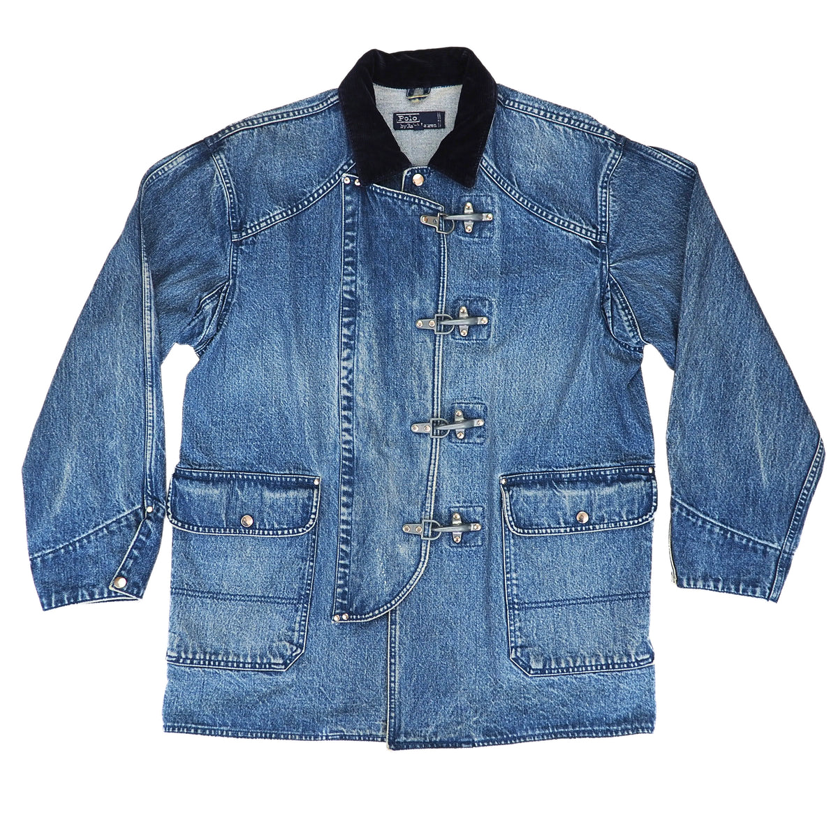 A blue denim jacket with a black corduroy collar and silver toggle closures, laid flat against a white background.