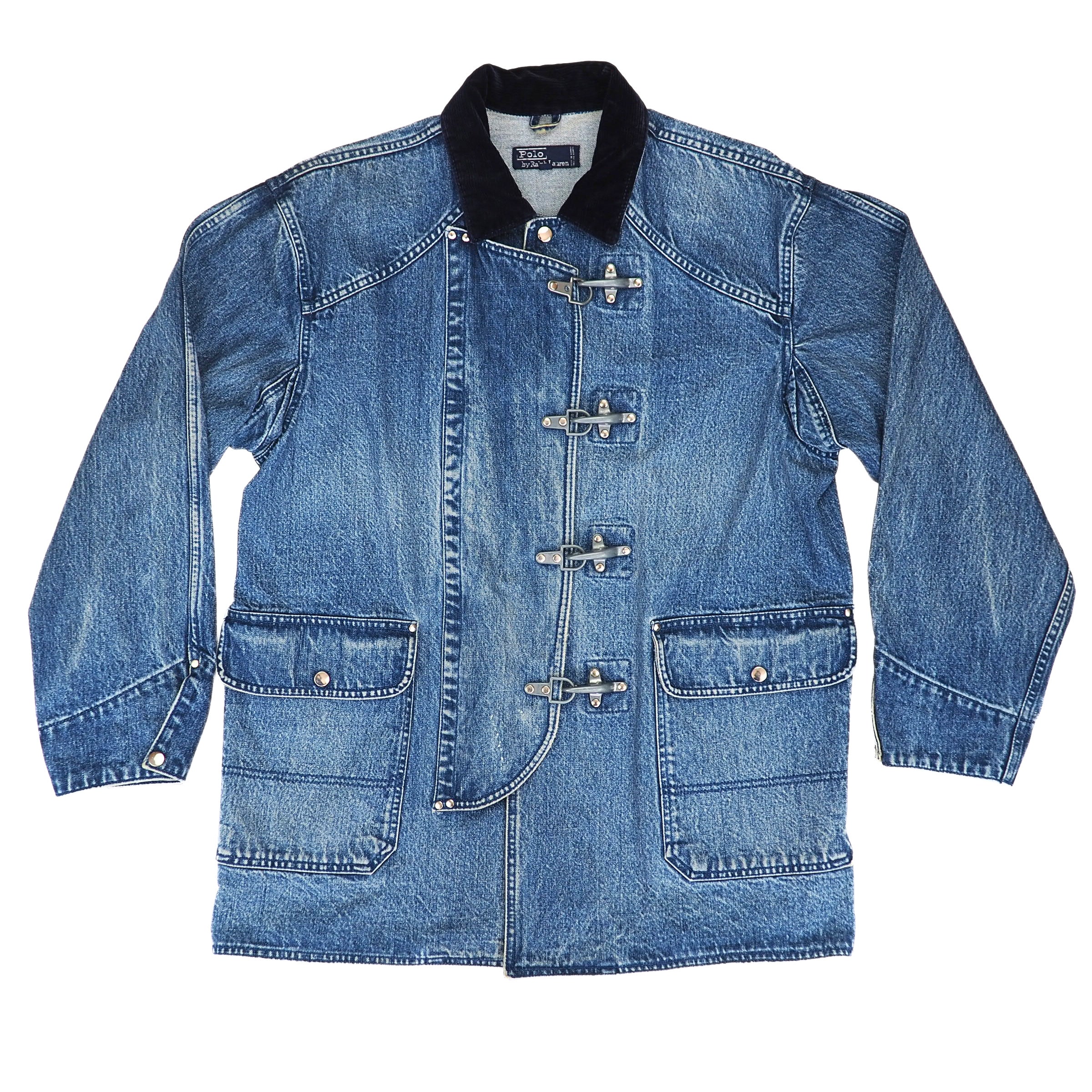 A blue denim jacket with a black corduroy collar and silver toggle closures, laid flat against a white background.