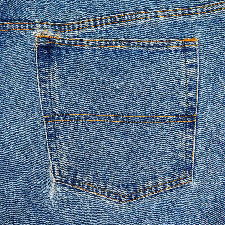 Close-up of a blue denim jean pocket with stitching details
