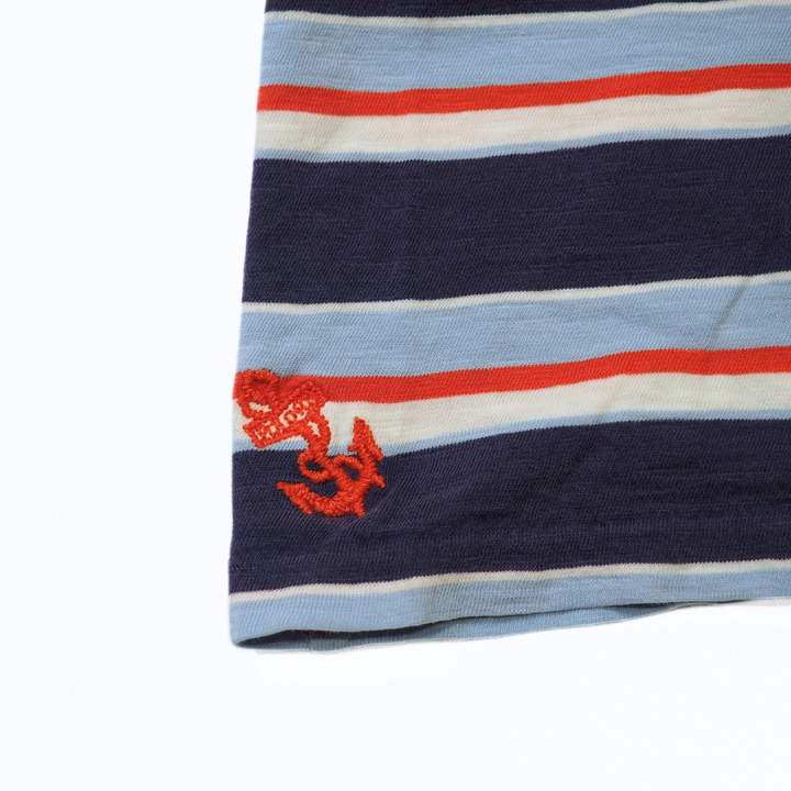 Striped fabric with red embroidered design on a white background