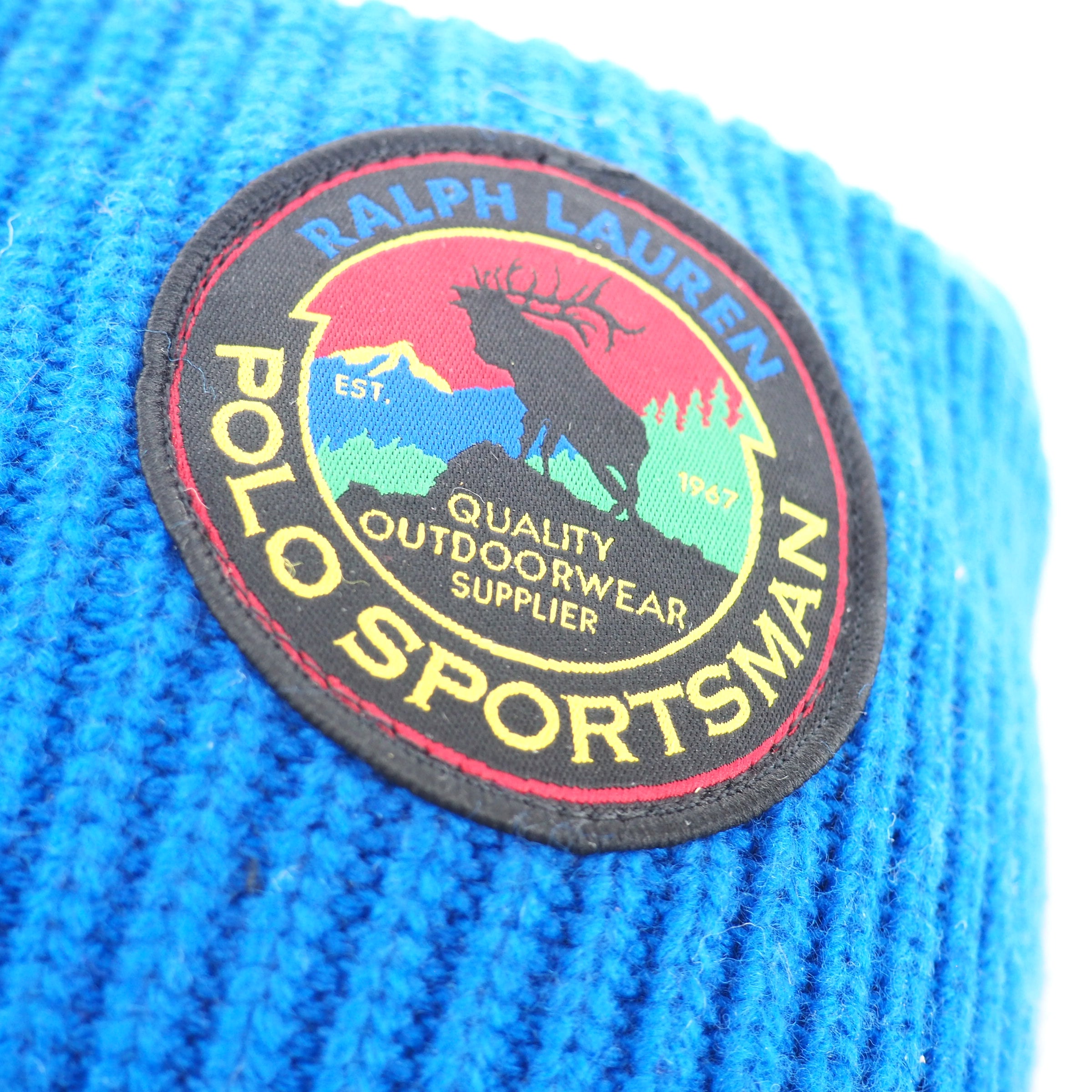 Close-up of a Ralph Lauren Polo Sportsman patch on blue knit fabric