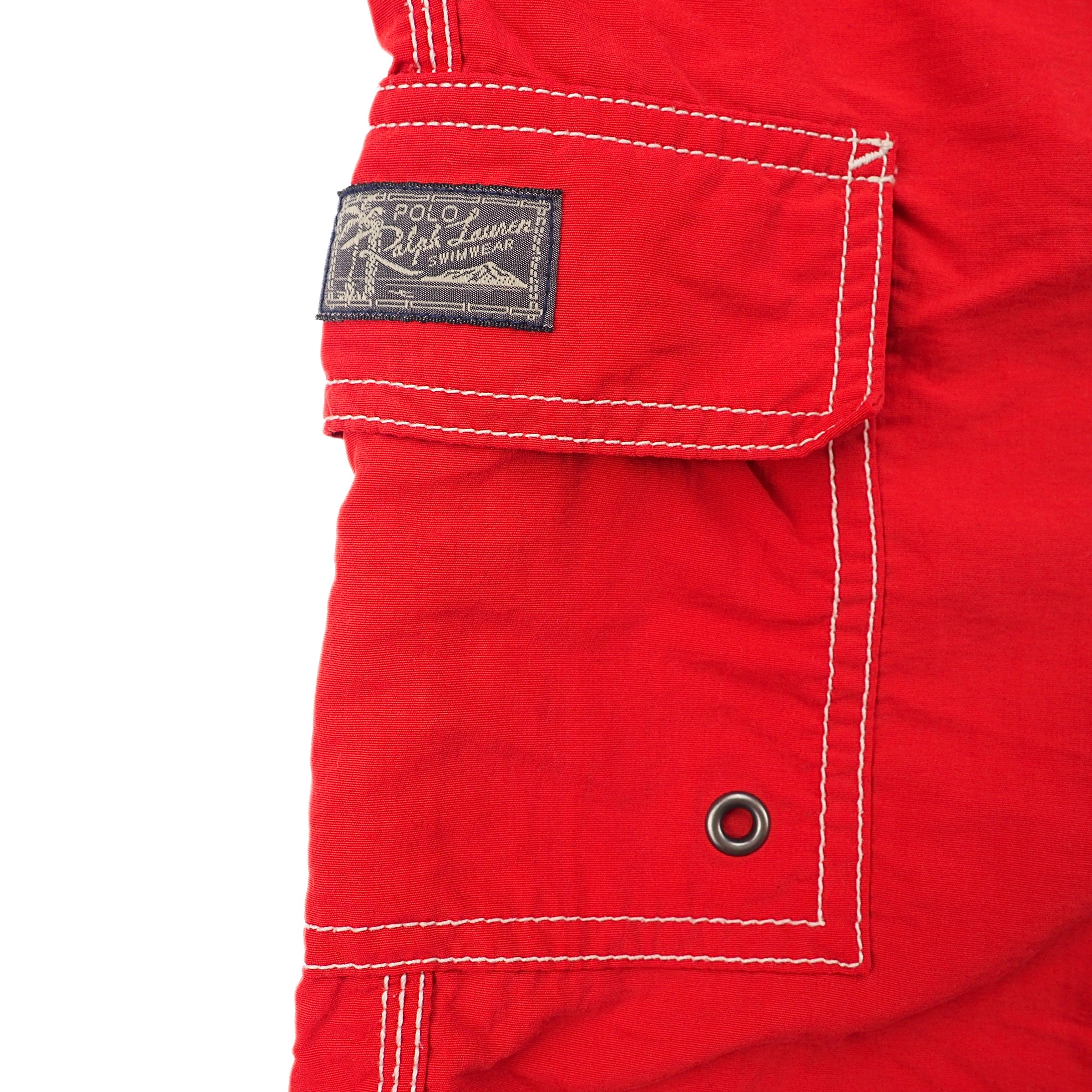 Close-up of a red pocket with a Ralph Lauren label on a white background