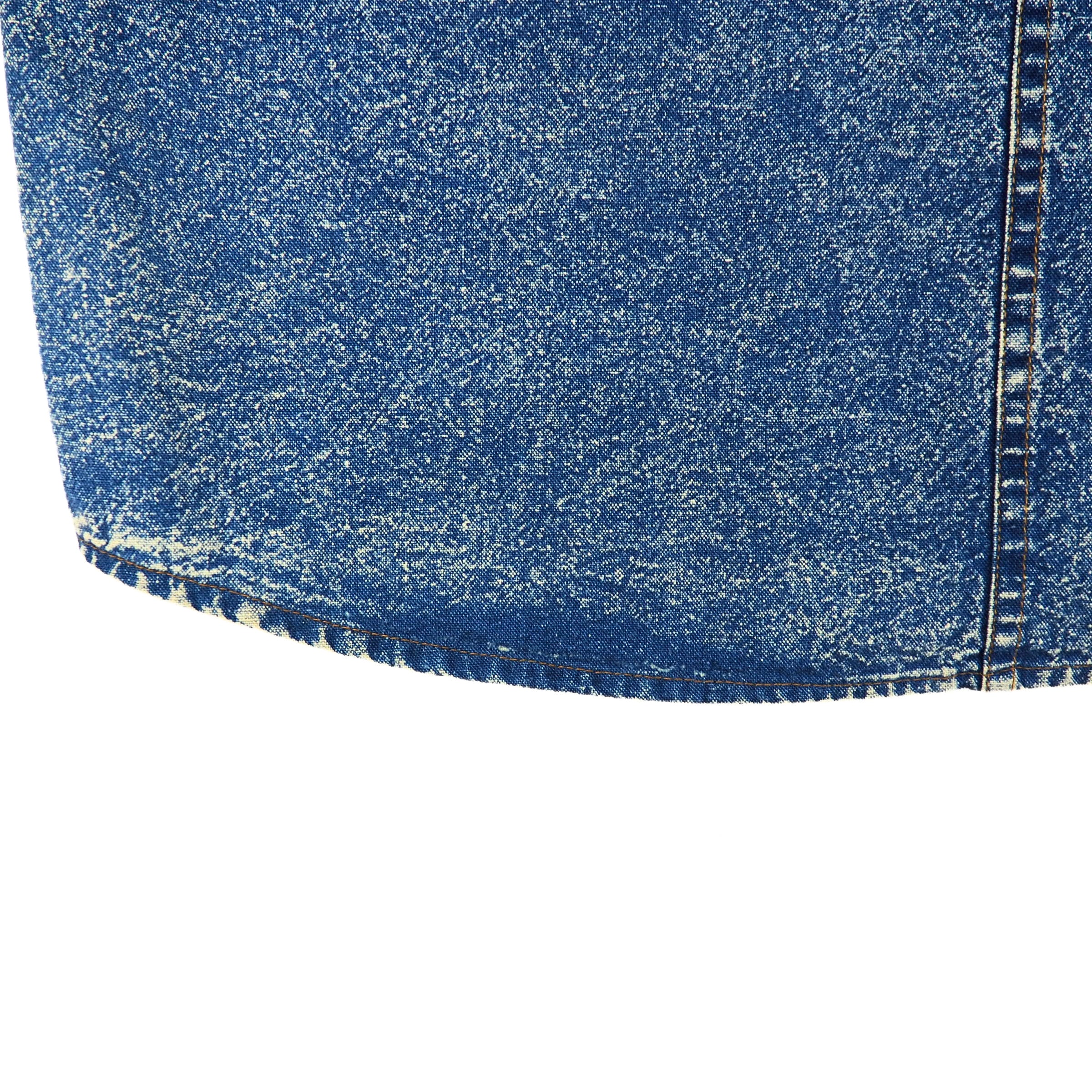 Close-up of blue acid wash denim fabric on a white background