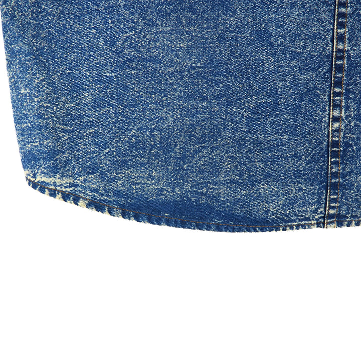 Close-up of blue acid wash denim fabric on a white background