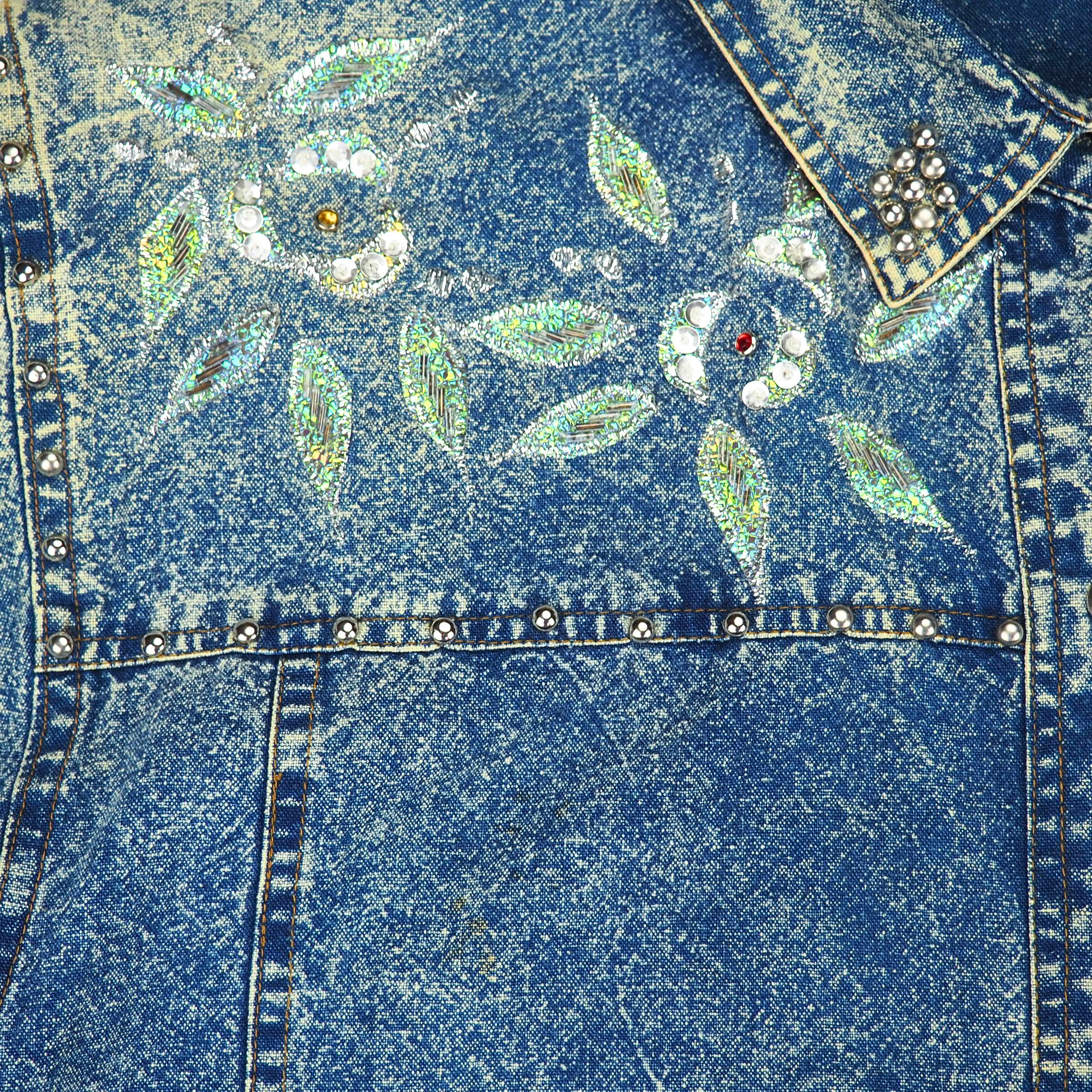 Blue denim shirt chest detail with floral embellishments and rhinestones