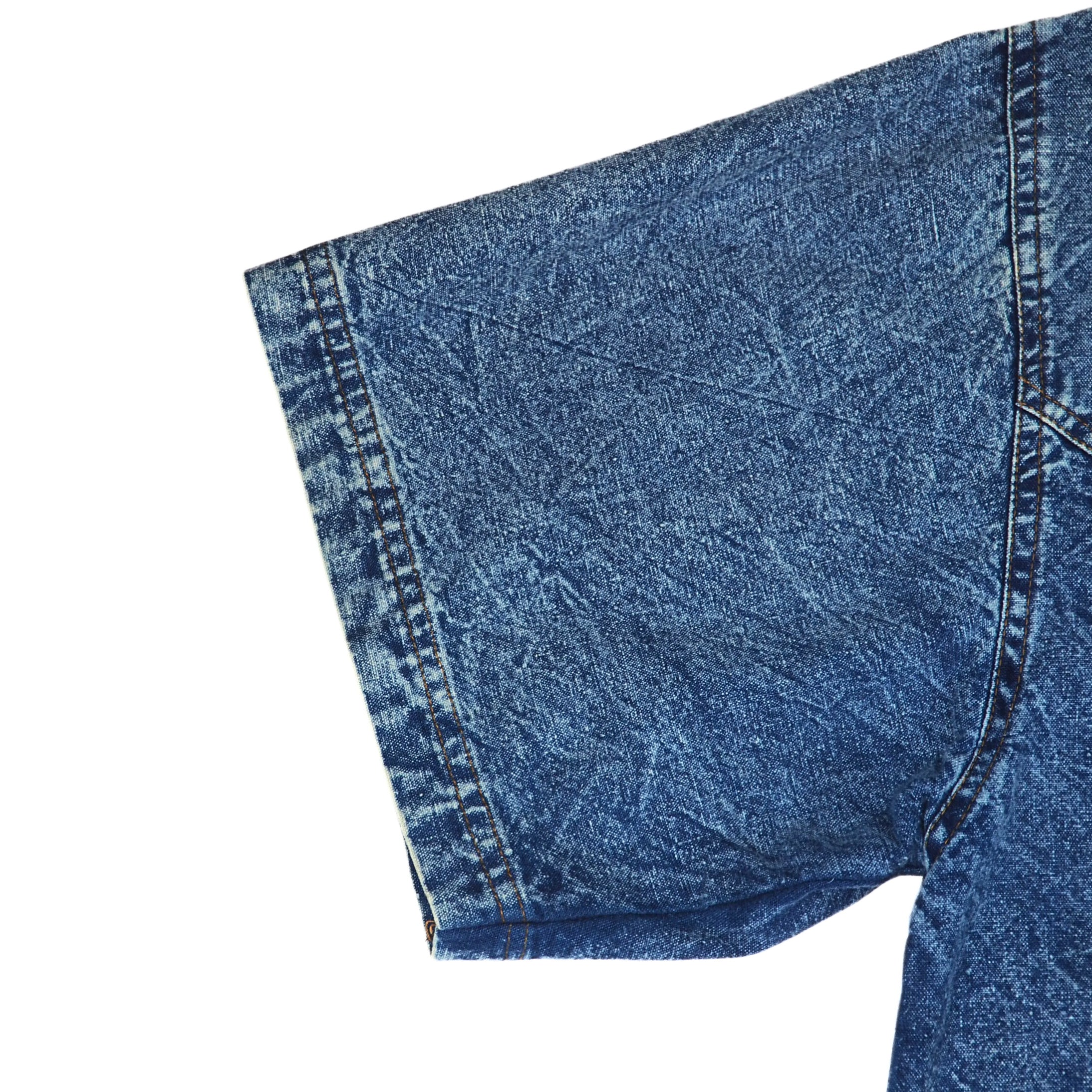 Close-up of blue short sleeved denim shirt on a white background