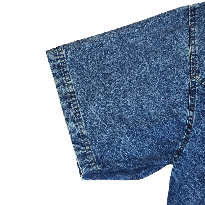 Close-up of blue short sleeved denim shirt on a white background
