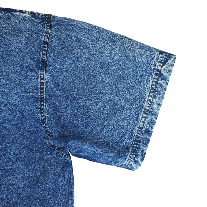 Close-up of blue acid wash denim shirt sleeve on a white background