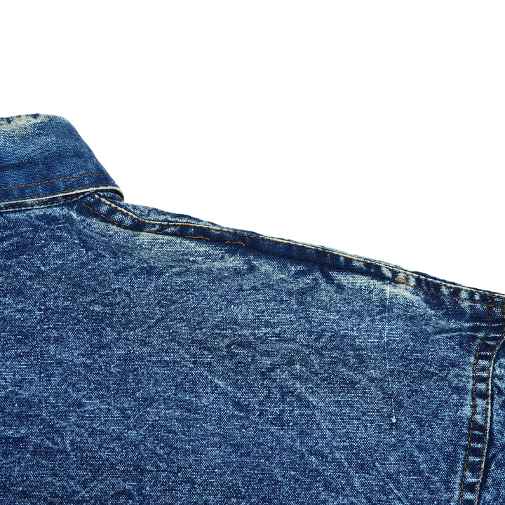 Close-up of blue denim fabric on a white background.