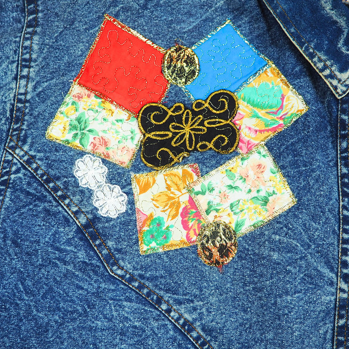 Colorful patchwork design and embroidery on a denim fabric background