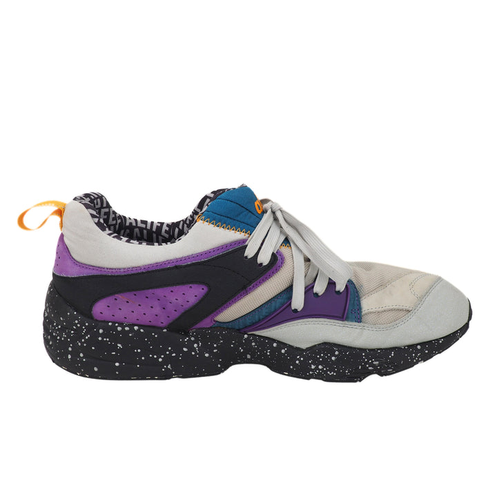 Multicolored sneaker with purple, black, and white design on a white background