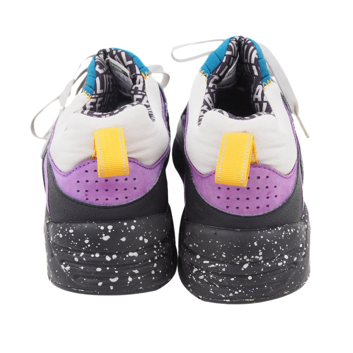 Pair of sneakers with purple, orange, and black design on a white background
