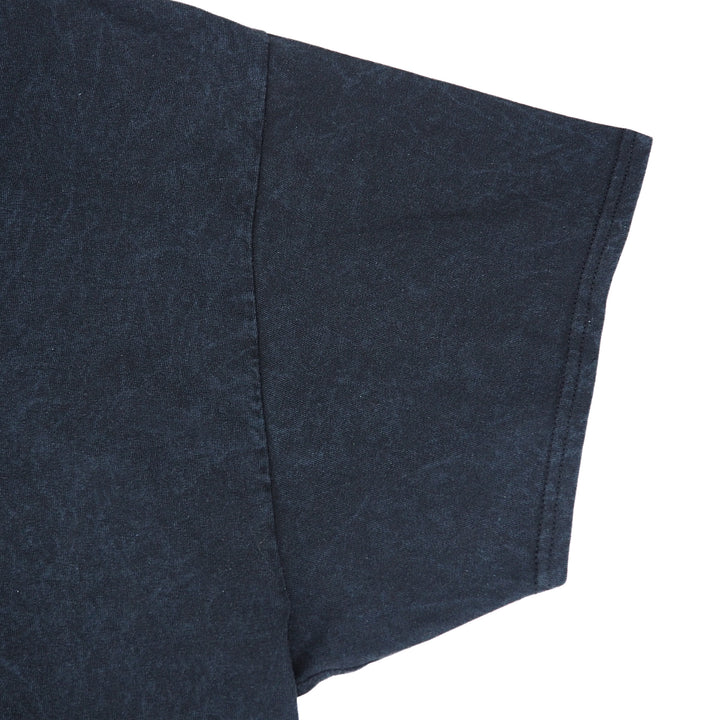 Close up of the sleeve of a black t-shirt on a white background