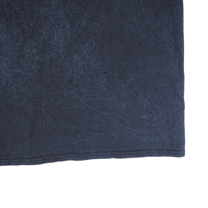 Close up of the hem of a black t-shirt on a white background