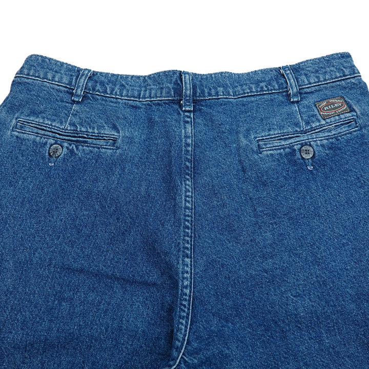 Rear seat area of a pair of blue denim jeans with a 'Riley' brand label on a white background