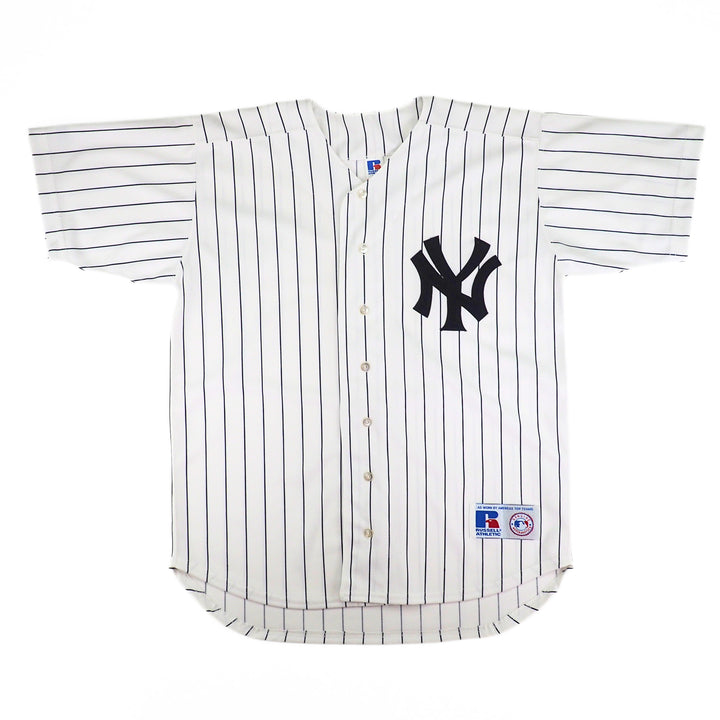 White baseball jersey with navy pinstripes and New York Yankees logo on a white background