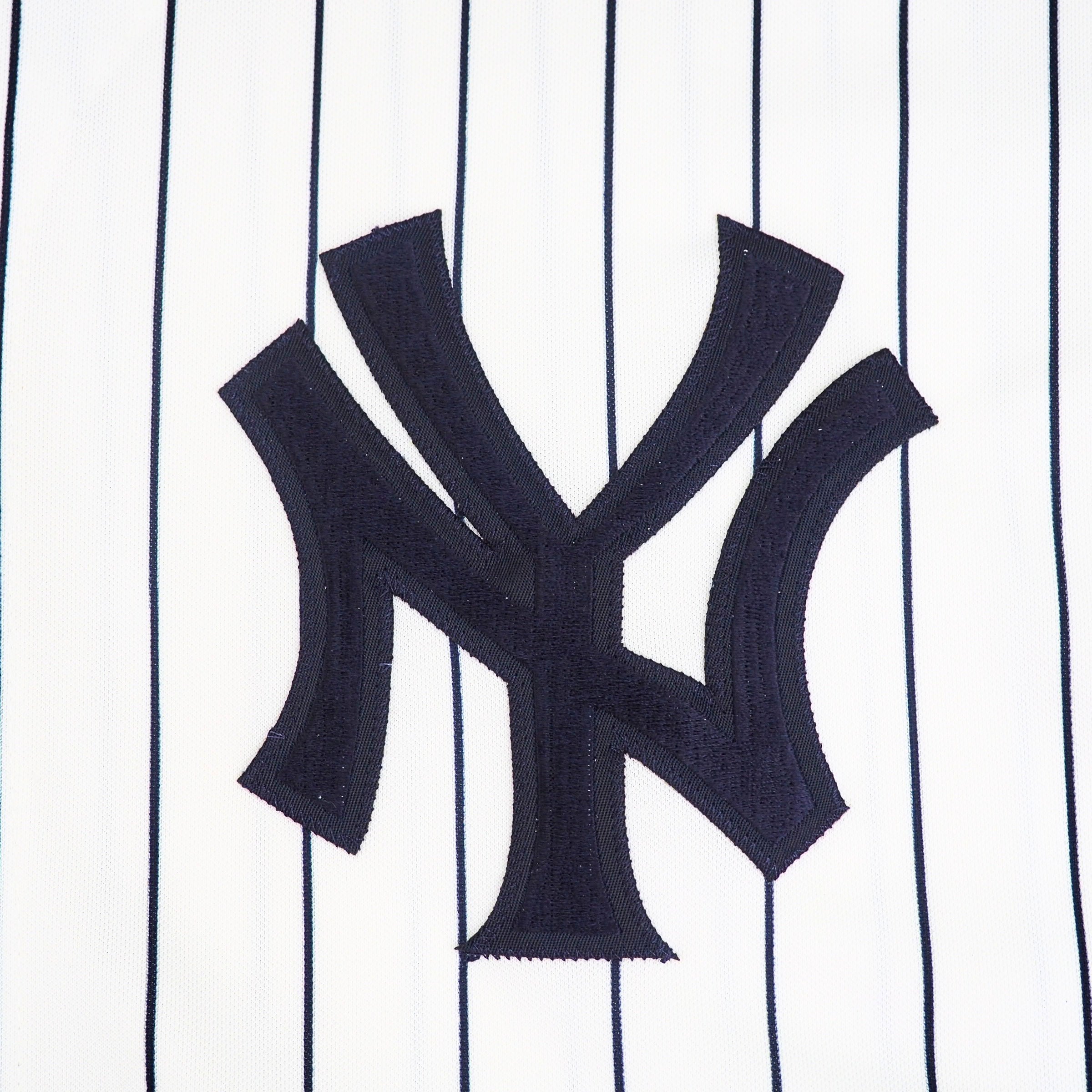 Close-up of the New York Yankees logo on a uniform with pinstripe pattern
