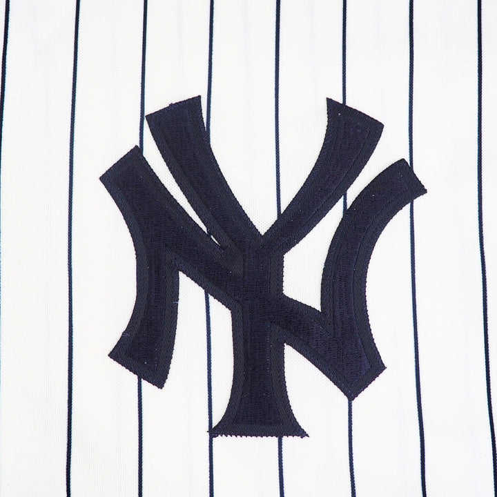Close-up of the New York Yankees logo on a uniform with pinstripe pattern
