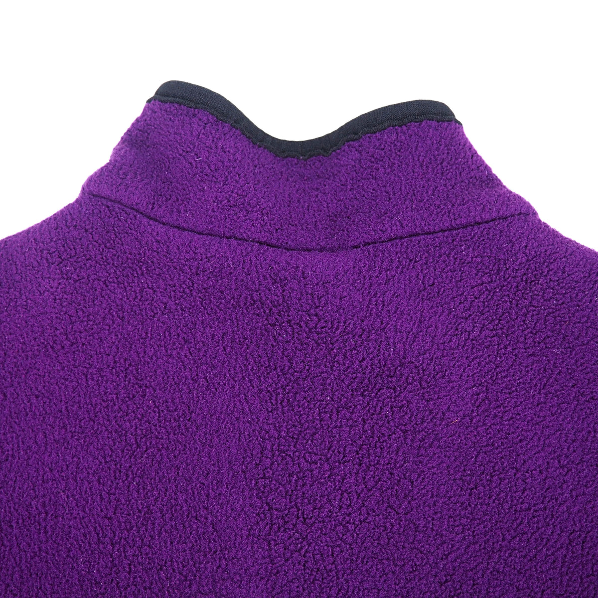Detail of the back shoulders and collar of a purple fleece with black trim.