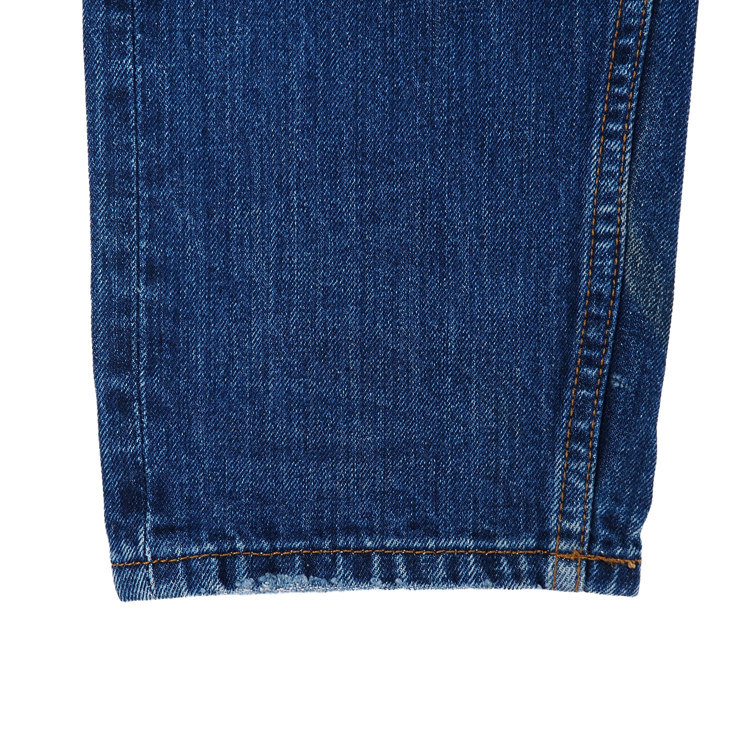 Close-up of blue denim jean ankle cuff with a white background