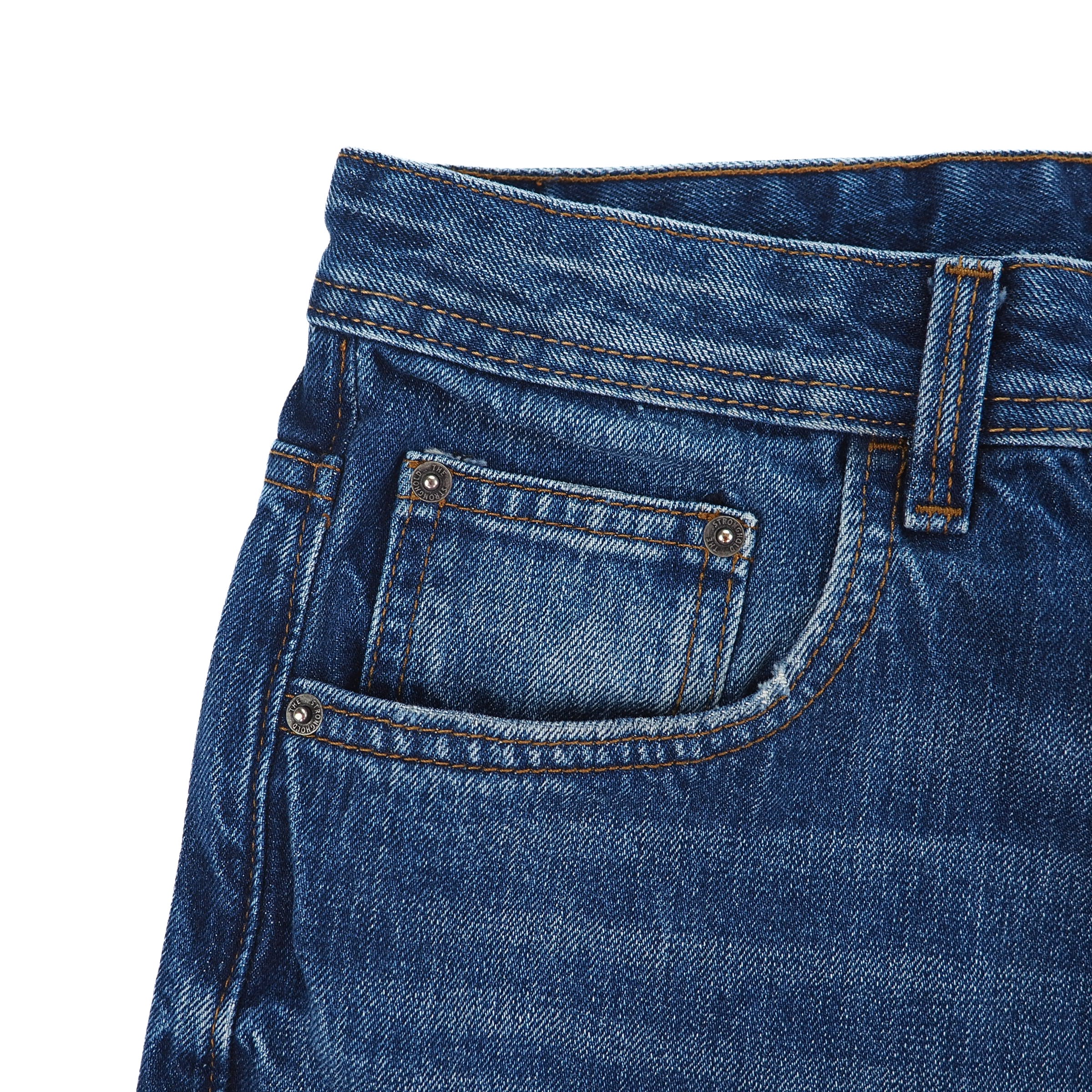 Close-up of blue denim jeans coin pocket on a white background