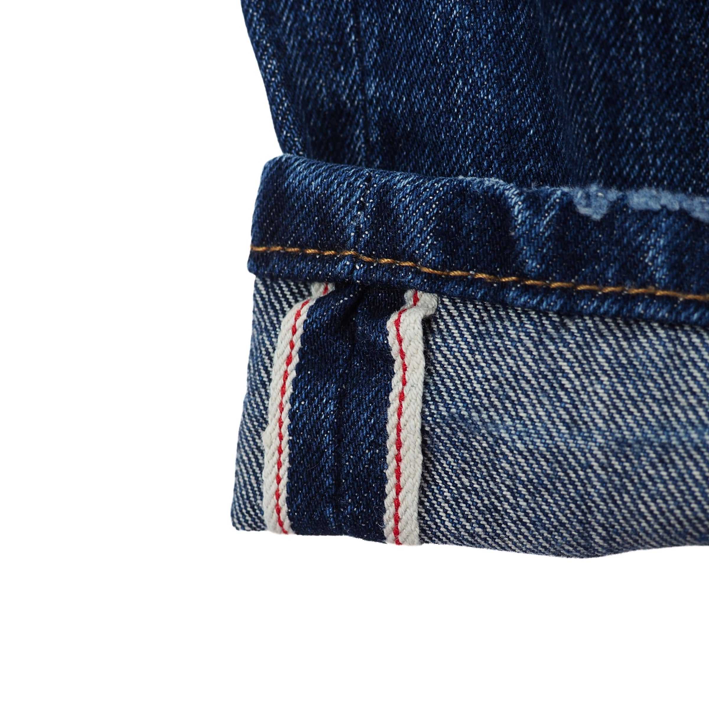 Close-up of blue japanese selvedge denim fabric with a white background