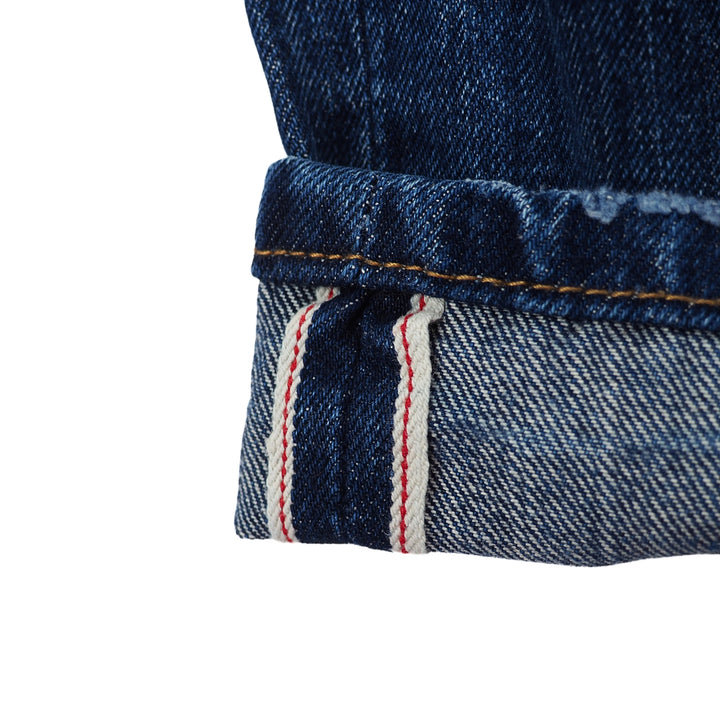 Close-up of blue japanese selvedge denim fabric with a white background