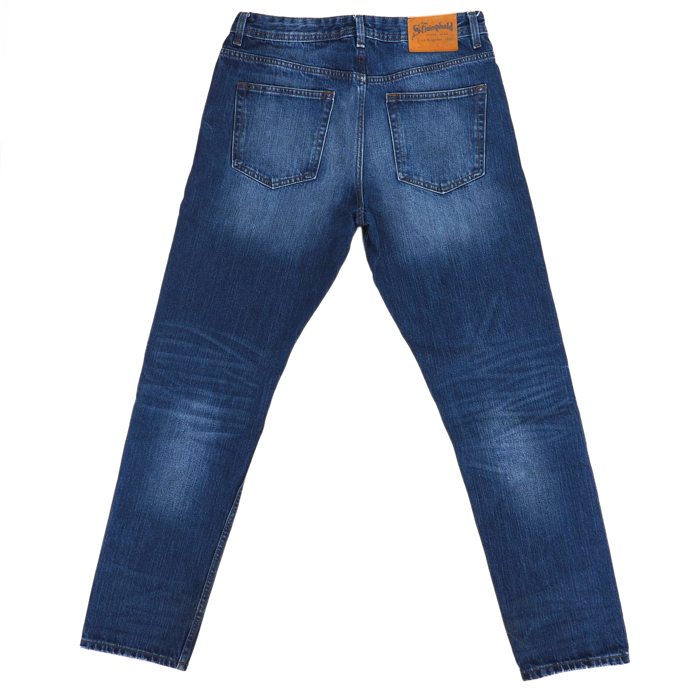 The Stronghold relaxed tapered japanese selvedge blue denim jeans on a white background